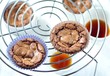 © tktyfy - freshly baked chocolate muffins cooling off on wire mesh