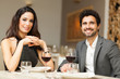 © Minerva Studio - Couple toasting wineglasses in a luxury restaurant