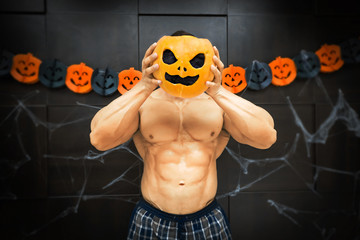 Halloween bodybuilder with pumpkin