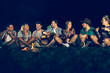 © NDABCREATIVITY - Friends enjoying music near campfire