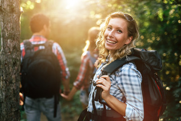 Wall Mural - group of people hiking in forest