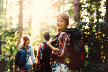 Wall Mural - group of people hiking in forest
