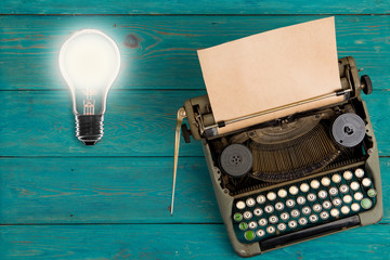 Fototapete - Idea concept- Vintage bulb and typewriter