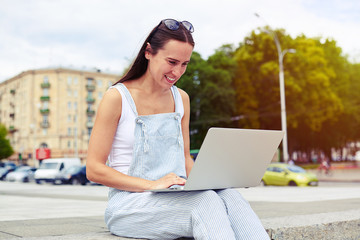 Poster -  Dark-haired attractive woman in overalls smiling while working