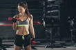 © fStop - Female athlete lifting dumbbells in gym
