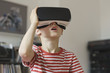 © fStop - Boy wearing virtual reality simulator at home