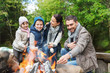 © Syda Productions - happy family roasting marshmallow over campfire