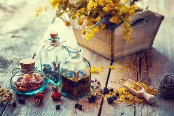 Wall Mural - bottles of tincture and dry healthy herbs, wooden scoop, bunch o