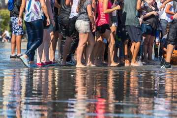 Poster - People having fun in a mirror fountain in Bordeaux, France