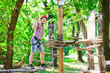 © davit85 - adventure climbing high wire park - people on course in mountain