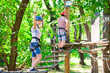 © davit85 - adventure climbing high wire park - people on course in mountain