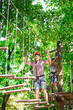© davit85 - adventure climbing high wire park - people on course in mountain