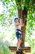 © davit85 - adventure climbing high wire park - people on course in mountain