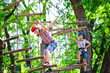 © davit85 - adventure climbing high wire park - people on course in mountain