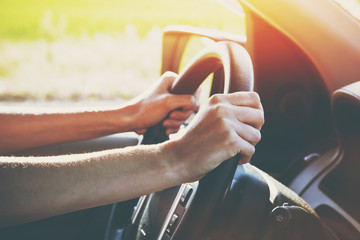 hands on steering wheel driving car