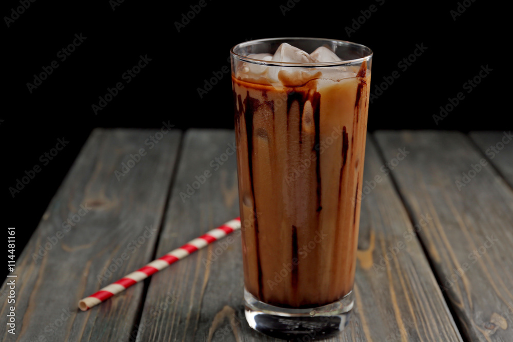 Glass of iced coffee on wooden table