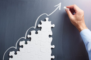 Poster - Steps shaped jigsaw puzzle. Drawing arrow on blackboard. Concept image of making business plan. 
