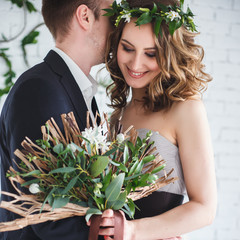 Bride and groom in elegant grey and green style over ecological natural decoration