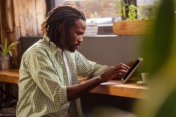 Poster - Man using a tablet sitting