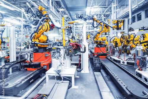Bras robotiques dans une usine automobile Tableau sur Toile
