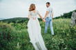 © ruslan_shramko - Happy Bride and groom walking on the green grass