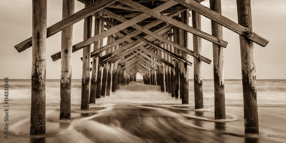 "Sepia Smooth"  The Ocean Isle Beach Pier is quiet in January. The Atlantic Coast of North Carolina is surreal and peaceful in the off season.  - obrazy, fototapety, plakaty 