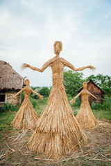 large handmade doll amulet near a wooden house