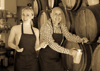 Portrait of two adult happy wine makers