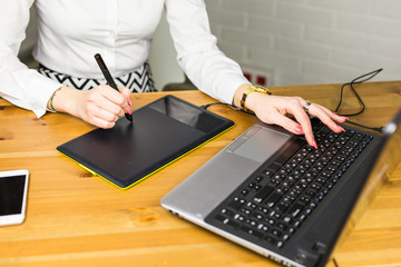 Fototapete - Close-up of designer using graphics tablet while working with computer