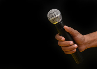 Professional holding microphone in hand while giving motivational speach