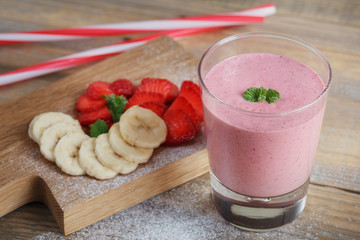 Delicious strawberry and banana smoothie or milk shake with fres