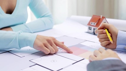 Poster - woman and architect discussing blueprint of house