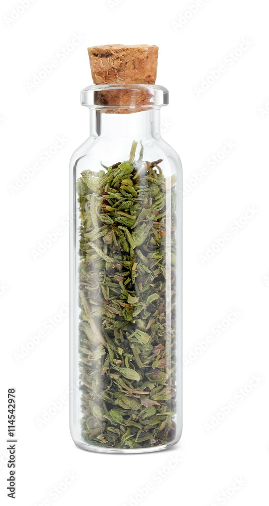 Dried tarragon in glass bottle on white background