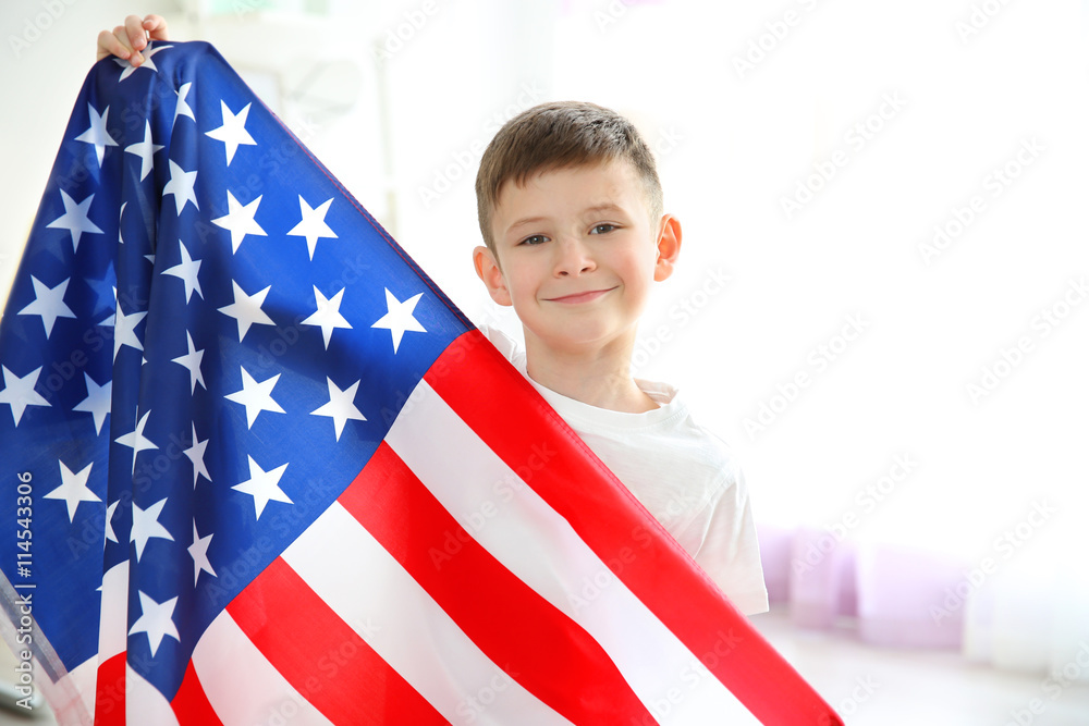 Boy and big American flag in room