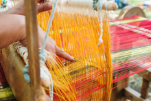 Weaving On A Wooden Loom