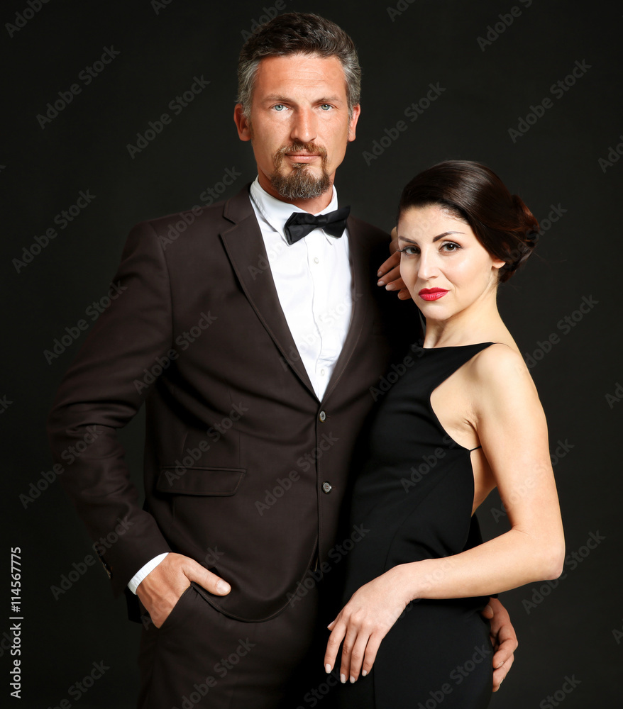 Happy mature couple on dark background