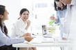 © Monet - Business people are talking with a laugh during a break