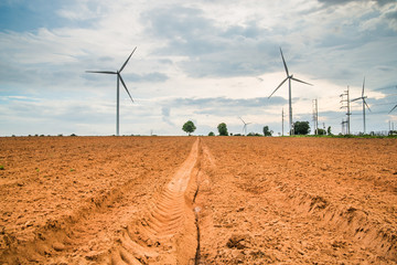 Wind turbines generate electricity at field all agriculture plantation in thailand