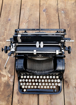 old typewriter with Russian letters on a wooden background