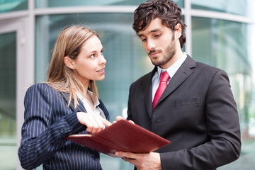 Wall Mural - Business colleagues reading a document