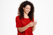 © Cookie Studio - Picture of cheerful curly girl chatting on her phone
