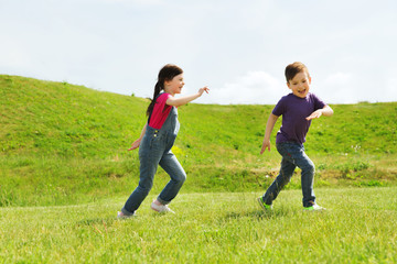 Poster - happy little boy and girl running outdoors