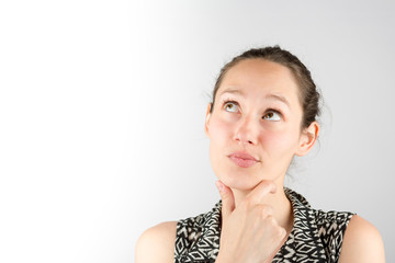 Portrait of a beautiful woman cogitate isolated on a white backg