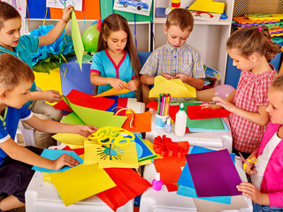 Wall Mural - Group kids holding colored paper on table in kindergarten . Children writting letter Santa Claus.