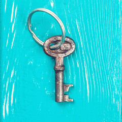 old key on a blue wooden background