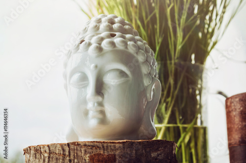 Zen Spiritual Ritual Meditating White Face Of Buddha Brown Candle On Green Floral Background Religion Concept Esoterics Still Life Style Home Decor Place For Text Copy Space Stock Photo Adobe Stock
