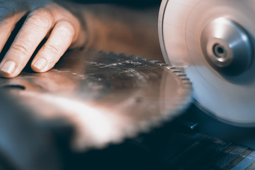 Sharpening Circular Saw, worker sharpens a circular saw blade