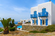 Typical white house with blue windows and balconies on Mykonos island, Greece