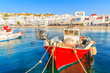 Typical red color Greek fishing boat in Mykonos town port on island of Mykonos, Cyclades, Greece