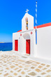 A traditional church with red doors on Mykonos island, Cyclades, Greece